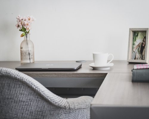 office worker doing light stretching at desk